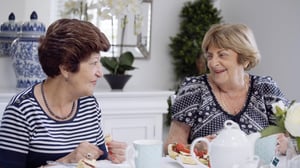 Two ladies eating scones