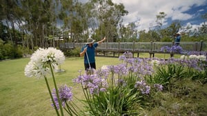 Gardeners waving near bridge
