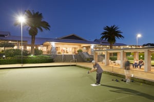 Men playing bowls at night